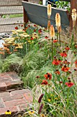 BORDER BY STEPS WITH HELENIUM ACHILLEA GRASSES AND KNIPHOFIA