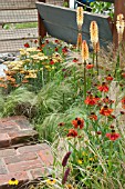 BORDER BY STEPS WITH HELENIUM ACHILLEA GRASSES AND KNIPHOFIA
