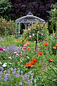 PAPAVER ORIENTALE  ORIENTAL POPPY  ROSA  ROSE  PAEONIA  PAEONY  WITH GARDEN PAVILION. DESIGN: MARIANNE AND DETLEF LUEDKE