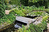 GARDEN POND WITH STONE BRIDGE. DESIGN: MARIANNE AND DETLEF LUEDKE