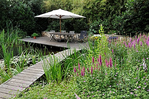WOODEN_DECKING_AREA_WITH_SEATS_AT_A_SWIMMING_POND