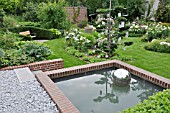 WATER BASIN AT THE EDGE OF A ROSE GARDEN