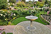 GRANITE FOUNTAIN IN A ROSE GARDEN