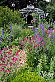 LYCHNIS CORONARIA  CROWN PINK  CONSOLIDA AJACIS  LARKSPUR  IN FRONT OF A GARDEN PAVILION. DESIGN: MARIANNE AND DETLEF LUEDKE