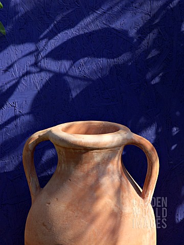STONEWARE_JUG_IN_FRONT_OF_A_BLUE_WALL