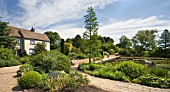 RHS GARDEN HYDE HALL IN JUNE. THIS IS THE VIEW THAT GREETS YOU AS YOU ENTER THE GARDENS. THE HOUSE,  WHICH DATES BACK TO THE 18TH CENTURY,  IS A TYPICAL ESSEX FARMHOUSE OF TIMBER FRAME,  LATHE AND PLASTER.