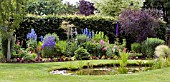 A COTTAGE GARDEN STYLE BORDER WITH POND