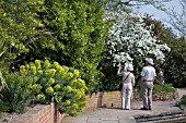 VISITORS TO  RHS GARDEN,  HYDE HALL STROLL THROUGH THE GARDENS BY THE TOP POND