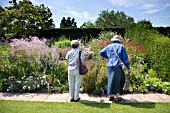 LADIES STUDY THE HERBACEOUS BORDERS AT RHS HYDE HALL GARDENS