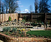 NEW GARDEN IN DEVELOPMENT 1 FEBRUARY WINTER. VIEW ACROSS THE GARDEN TO POND AND ROCKERY.