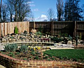 NEW GARDEN IN DEVELOPMENT 1 FEBRUARY WINTER. VIEW ACROSS THE GARDEN TO POND AND ROCKERY.