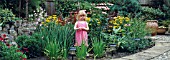 POND FILLED IN TO MAKE GARDEN AND AREA SAFE FOR CHILDREN, SHOWING YOUNG GIRL, (LAST NO 6 OF SEQUENCE)