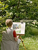 ARTIST PAINTING UNDER MAGNOLIA (WEST DEAN GARDENS)