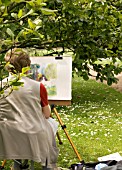 ARTIST PAINTING UNDER MAGNOLIA (WEST DEAN GARDENS)