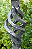 DECORATIVE IRON RAILING DETAIL AGAINST BOX HEDGE, BUXUS SEMPERVIVENS, JULY