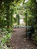 TABLE AND CHAIRS IN AN AUTUMN GARDEN