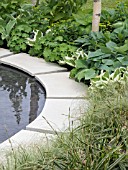 HOSTAS  BUXUS AND GRASSES PLANTED BESIDE A POND