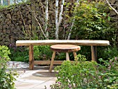 WOODEN STALL AND BENCH IN A COMPACT GARDEN